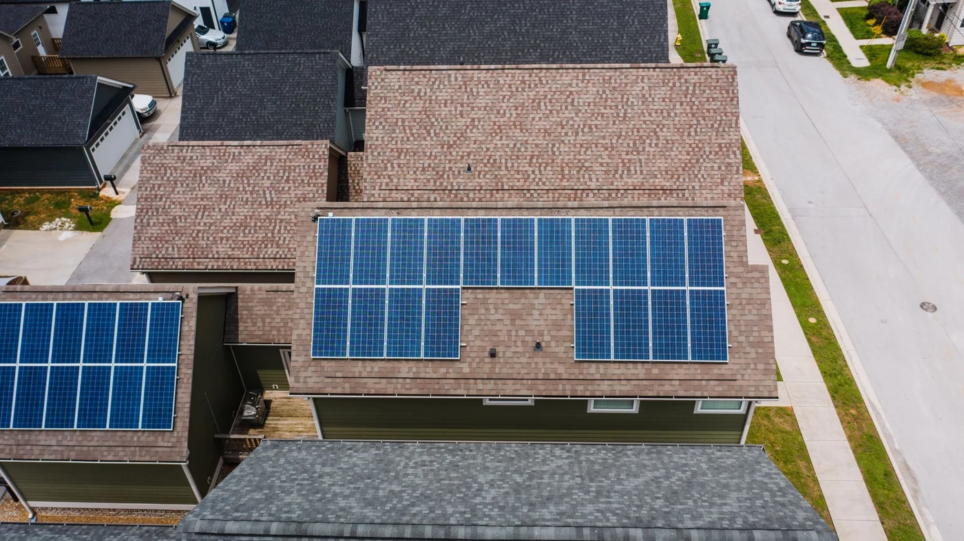 Residential rooftops with solar panels under sunlight